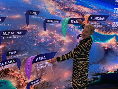 WorldDAB President Jacqueline Bierhorst stands in front of a map of Saudi Arabia